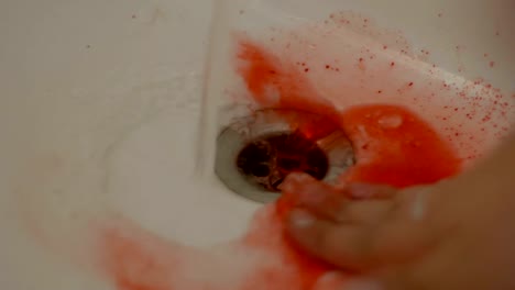 Female-hand-washing-dried-blood-from-sink,-household-injuries,-first-aid