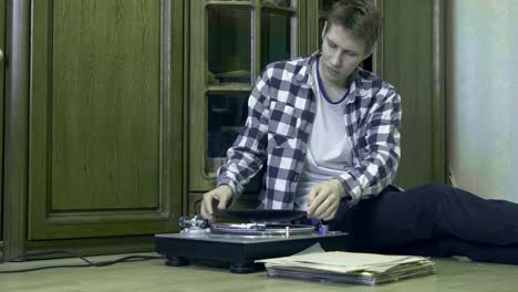 man-with-vinyl-records-in-hands-listens-to-the-music