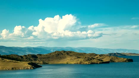 White-clouds-float-above-the-smooth-lake.