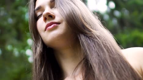 Woman-with-long-hair-raises-hair-up-senses-oneness-with-nature-female-feel-unity