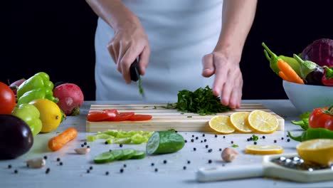 Man-is-chopping-parsley-in-the-kitchen