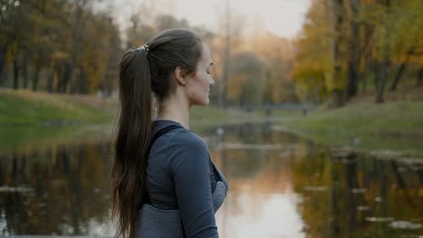 Young-woman-practicing-yoga-outdoors.-Female-meditate-outdoor-infront-of-beautiful-autumn-nature