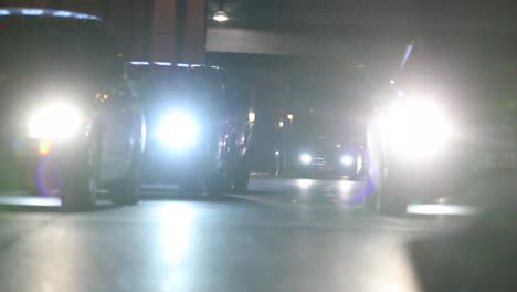 Blurred-abstract-Pedestrians-crossing-street-at-night-at-120fps-slow-motion.-Lens-flares-of-cars-in-the-background-with-crowd-of-people-in-the-foreground