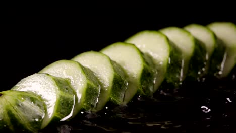 Falling-of-sliced-cucumber-into-the-wet-table.-Slow-motion-240-fps