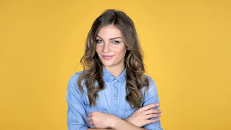 Young-Girl-Waving-Finger-to-Refuse-Isolated-on-Yellow-Background