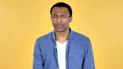 Young-African-Man-Shaking-Head-to-Reject-Isolated-on-Yellow-Background