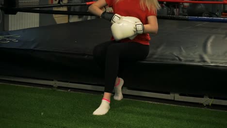 Cute-girl-boxer-sitting-in-the-ring-after-training