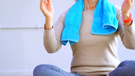 Senior-woman-performing-yoga-in-yoga-center-4k