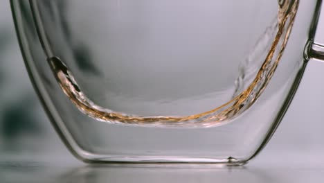 Tea-poured-into-a-glass-in-soft-slowmotion