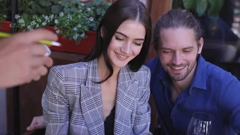 Couple-At-Restaurant.-People-With-Menu-Making-Order-At-Cafe