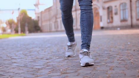 male-legs-walking-on-the-pavement