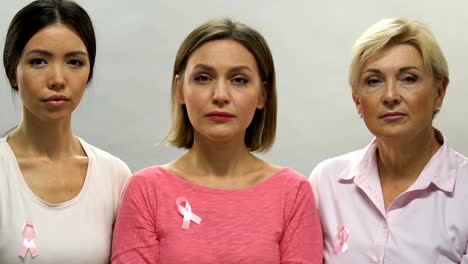 Portrait-of-sad-women-with-pink-ribbons,-breast-cancer-prevention,-bad-statistic