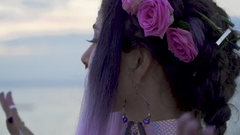 Close-up-portrait-of-sensual-young-woman-with-bright-makeup-pierced-nose-beautiful-eyes-and-a-flower-hairstyle.-Slow-motion.