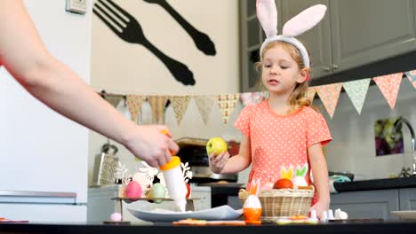 Woman-Decorating-Cookies-and-Girl-Watching-it