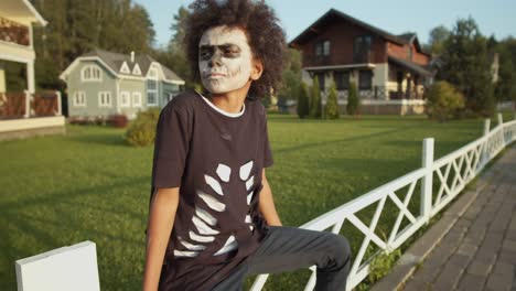 Boy-in-Halloween-Costume-Sitting-on-Fence