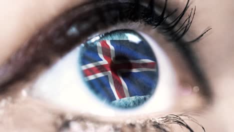 woman-blue-eye-in-close-up-with-the-flag-of-Iceland-in-iris-with-wind-motion.-video-concept