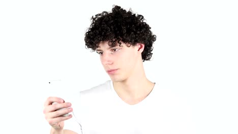 Using-Smartphone,-Texting-Young-Man-with-Curly-Hairs