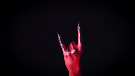 4k-Horror-Halloween-Devil's-Hand-Showing-Rock