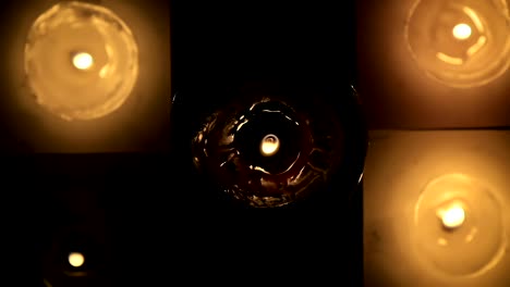 Abstract-a-lot-of-beautiful-wax-candles-burning-view-from-the-top-in-slow-motion.