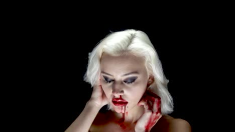 Fashion-blonde-in-harness-with-bloody-hands-and-face