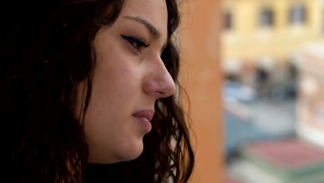 sad-pensive-woman-at-the-window-crying