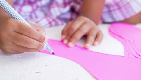 Close-up-kid-hands-using-the-colored-felt-pens-on-paper,-slow-motion-shot-in-50-fps