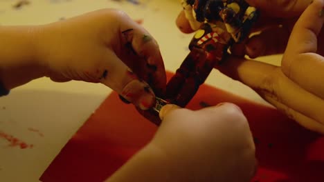 Video-Of-A-Young-Toddler-Boy-Making-A-Christmas-Wooden-Toy-Soldier-Craft-With-His-Mom-At-Their-Living-Room-Table