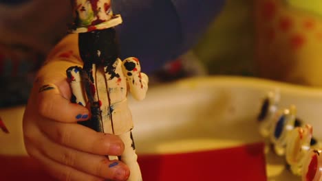 Video-Of-A-Young-Toddler-Boy-Making-A-Christmas-Wooden-Toy-Soldier-Craft-With-His-Mom-At-Their-Living-Room-Table