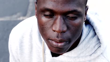 Close-up-on-proud-african-black-man-closing-his-eyes--outdoor