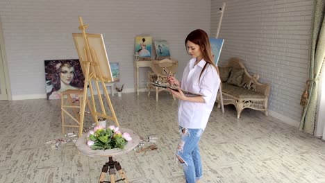 Portrait-of-girl-with-palette-of-colors-in-studio.