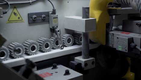 Close-up-shot-of-gears-rotating-in-a-edge-banding-machine