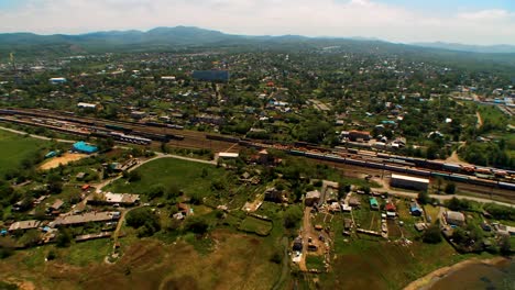 Helicopter-(-drone,-quadcopter-)-flies-over-the-settlement,-the-railway