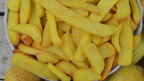 Homemade-baked-potato-fries-on-white-wooden-board.-Top-view.-Flat-view