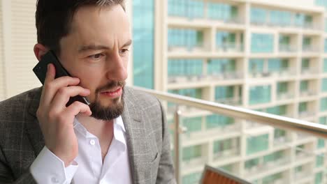 Portrait-of-angry-businessman-talking-loudly-on-the-phone