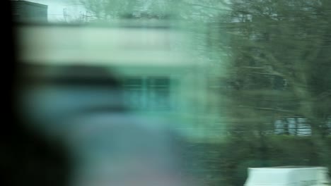 Urban-city-landscape-seen-from-a-moving-train-in-motion