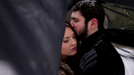 Bride-with-the-black-veil-and-the-groom-in-snow.