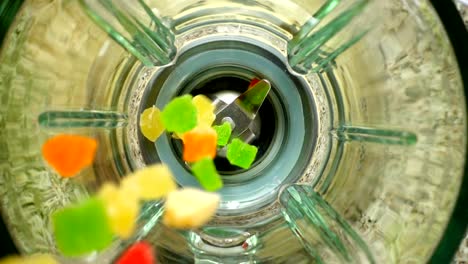 Falling-of-succade-in-a-blender-bowl.-Slow-motion.	Top-view.