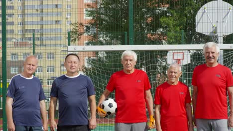 Senior-Friends-Standing-at-Goal-Net