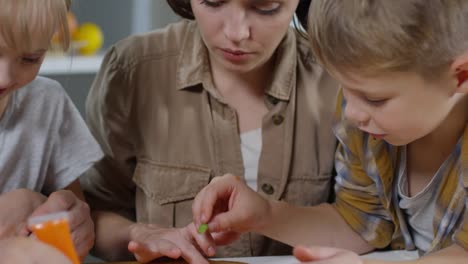 Parents-and-Kids-Decorating-Halloween-Pumpkin-Cookies