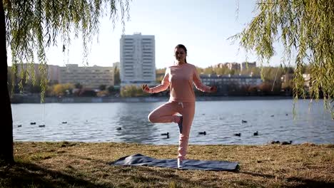 Girl-in-headphones-on-the-promenade-in-yoga.