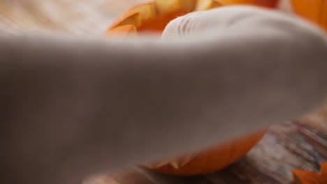 close-up-of-woman-with-halloween-pumpkin-at-home