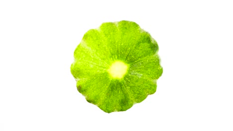 One-green-patty-pan-summer-squash-rotating.-Isolated-on-the-white-background.-Close-up.-Macro.