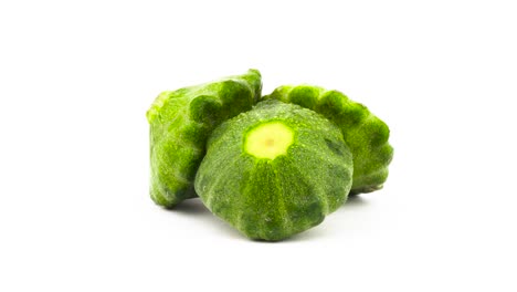 Three-whole-green-pattypan-summer-squash-rotating.-Isolated-on-the-white-background.-Close-up.-Macro.