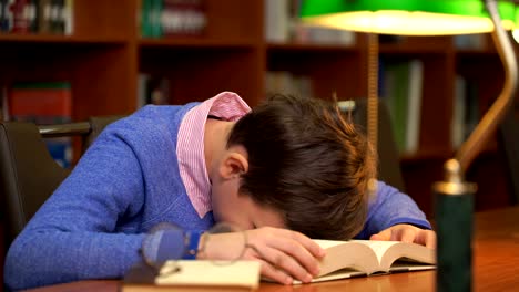 portrait-of-schoolboy-doing-their-homework-and-sleeping-on-the-book