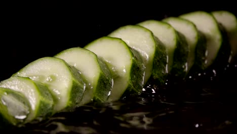 Falling-of-sliced-cucumber-into-the-wet-table.-Slow-motion-240-fps