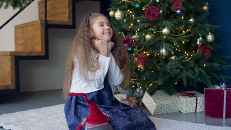 Joyful-dreamy-girl-making-a-wish-for-christmas