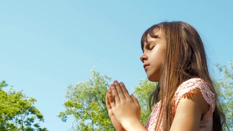 The-child-prays-in-nature.