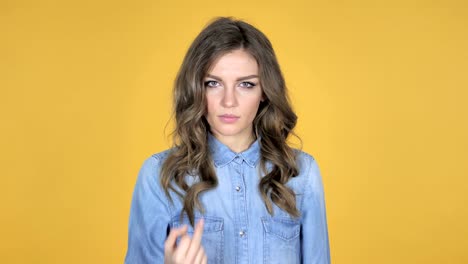 Young-Girl-Showing-Middle-Finger-Isolated-on-Yellow-Background