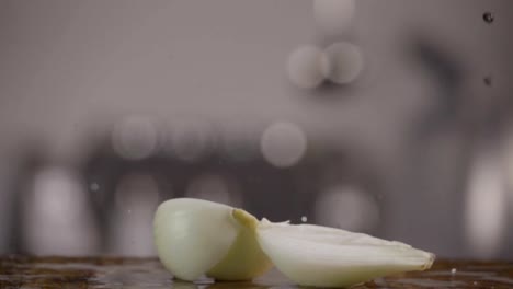 Falling-of-white-onion-into-the-wet-table.-Slow-motion-480-fps