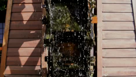 scenic-front-view-of-an-old-river-water-wheel-spinning-in-the-sun